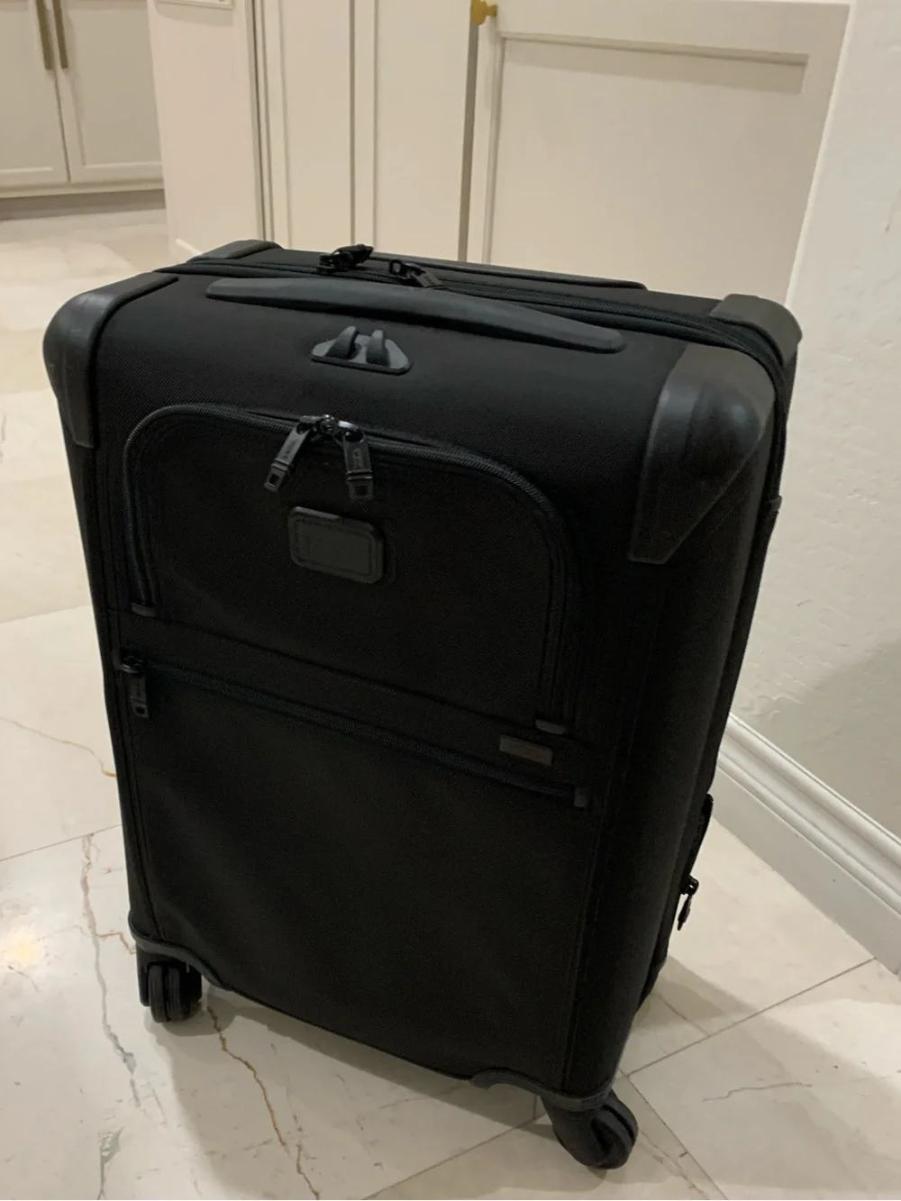 Tumi Black Spinner Carry-On with Front Zip Pocket luggage